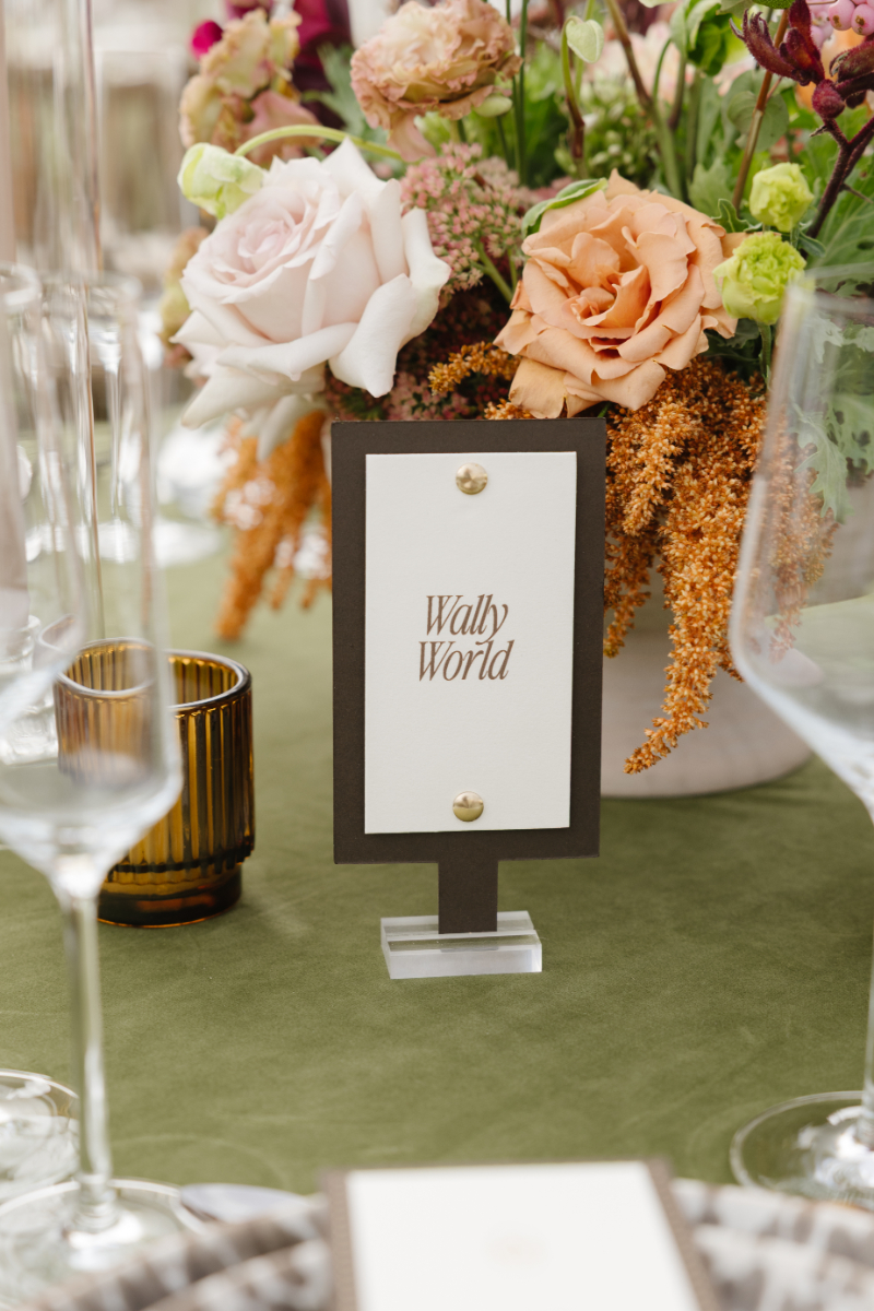 Documentary style wedding photography capturing a refined table number display with soft florals and layered textures at a Jackson Hole reception