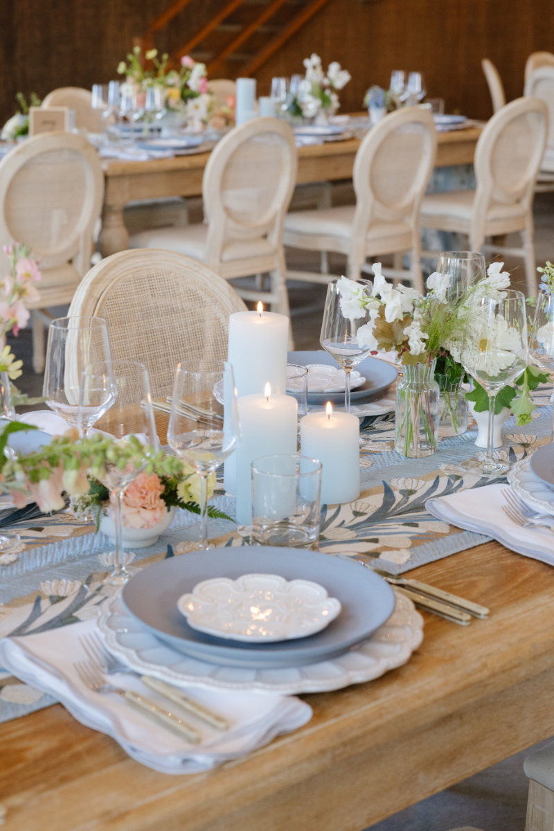 Candlelit Western wedding tablescape in Jackson Hole with floral centerpieces, layered place settings, and romantic reception decor.