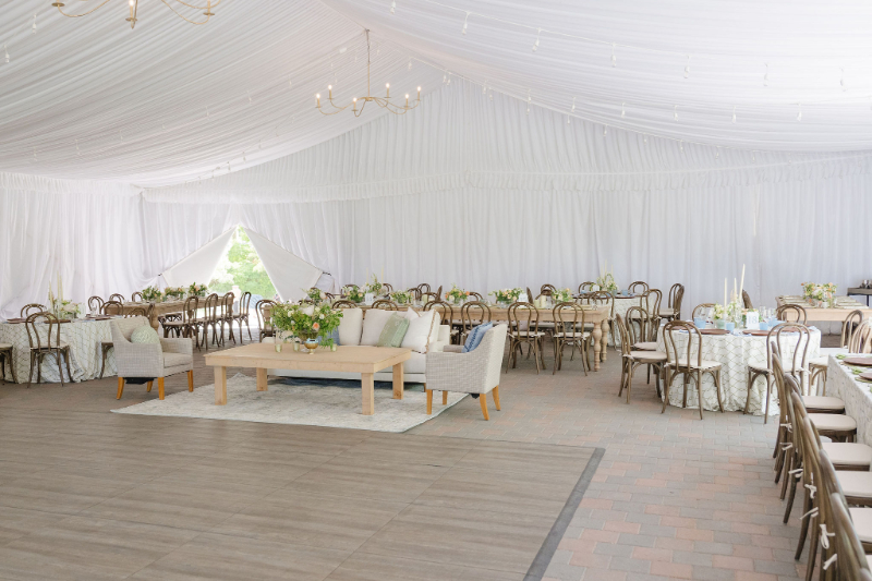Elegant tented reception space for a destination wedding in the mountains with soft draping, refined lounge seating, and timeless Jackson Hole wedding decor.
