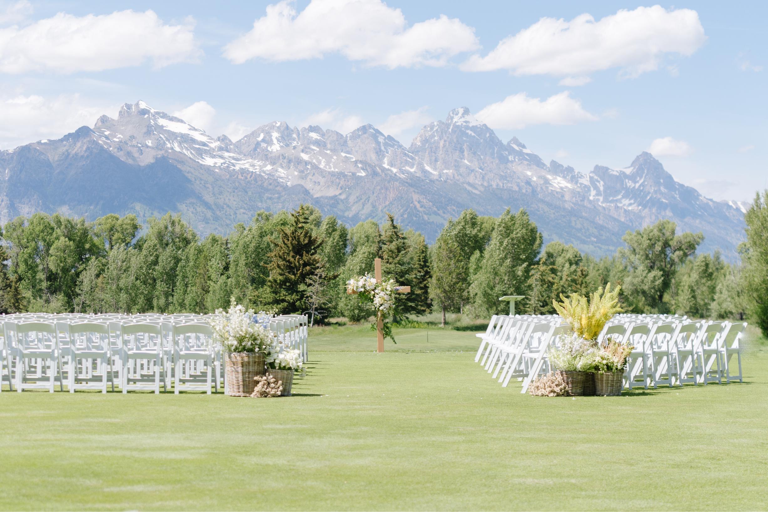 Ceremony setup at a Jackson Hole Golf and Tennis Club wedding with panoramic Teton Mountain views.