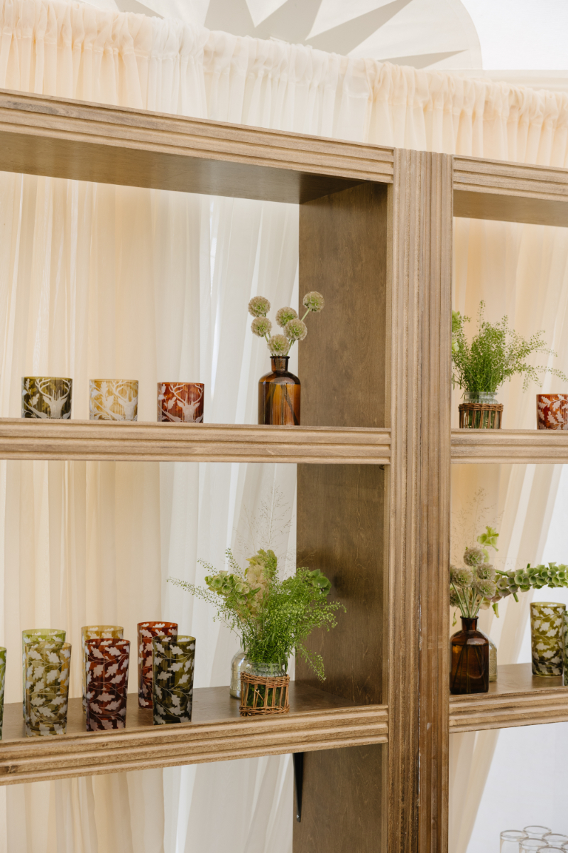Custom bar shelving with floral arrangements and thoughtful reception details