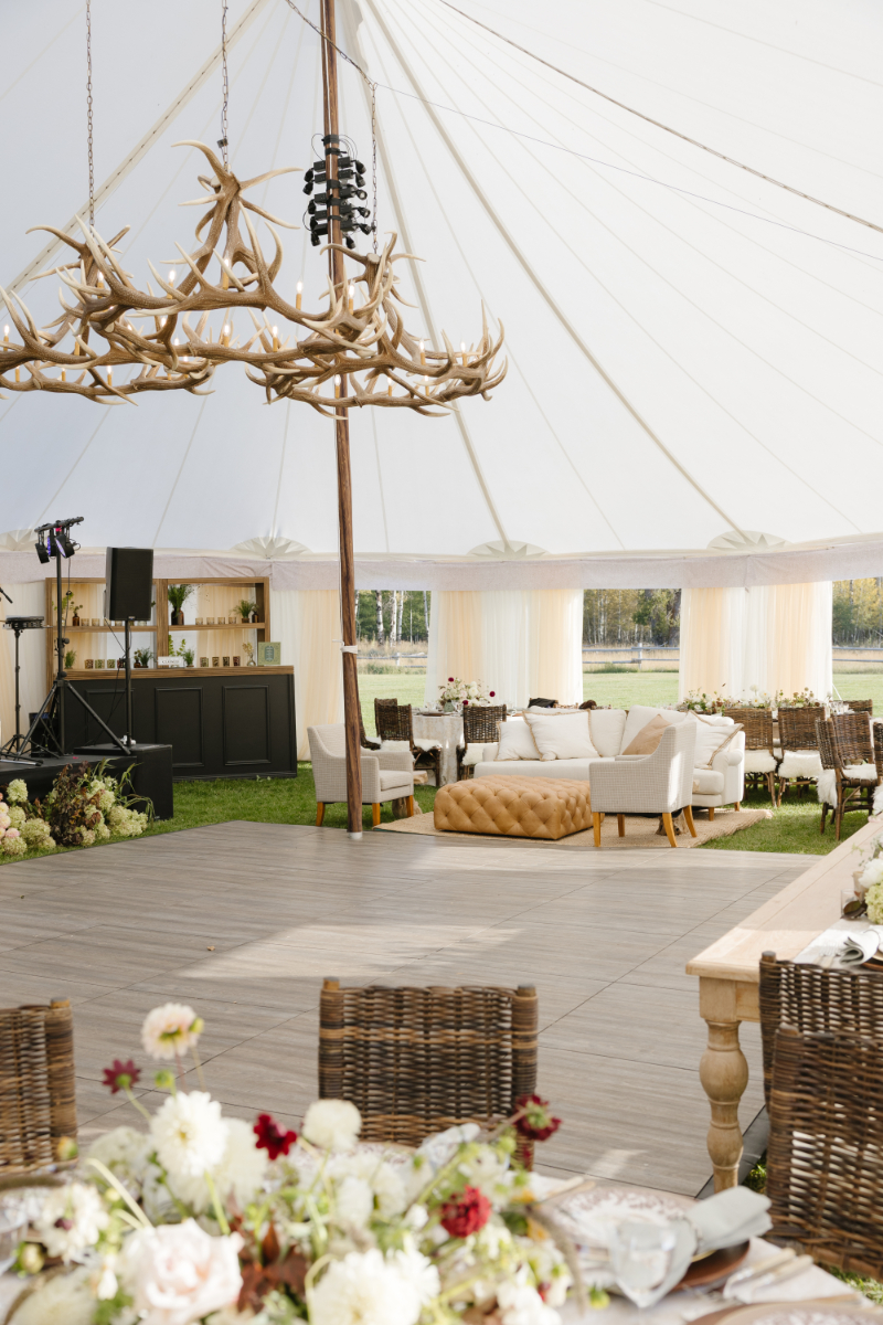 Snake River Ranch reception tent with lounge seating and antler chandeliers