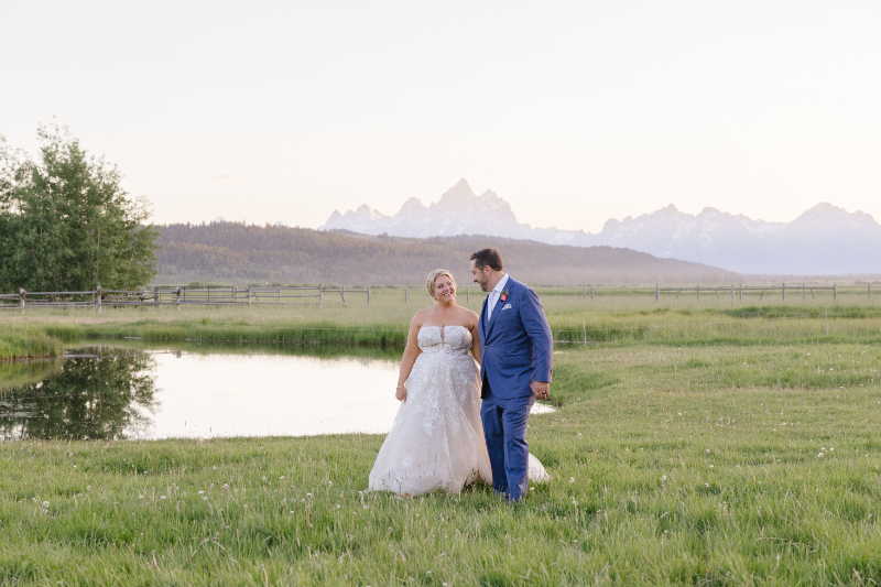 Jackson Hole blue hour photography featuring a couple walking near the Tetons at sunset