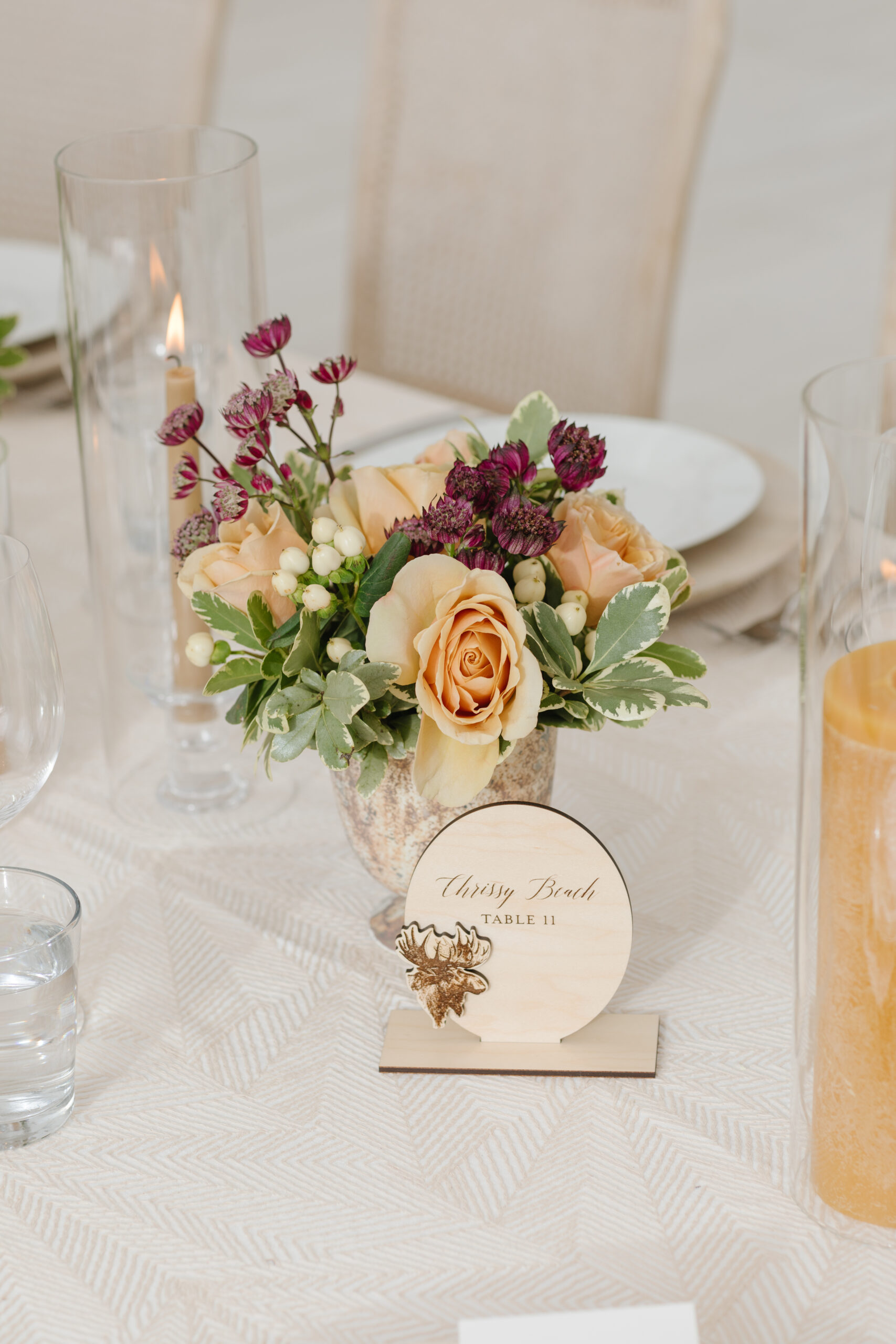 Fall wedding centerpiece with peach roses and table number at Jackson Hole reception
