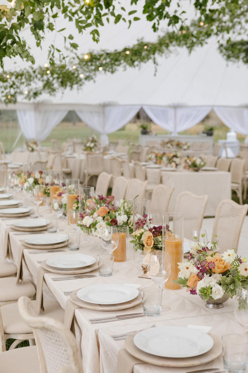 Elegant fall wedding reception tablescape beneath a tent in Jackson Hole