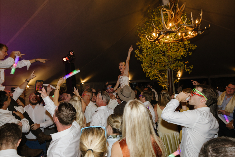 Bride crowd surfing during the dance party at Snake River Sporting Club wedding reception