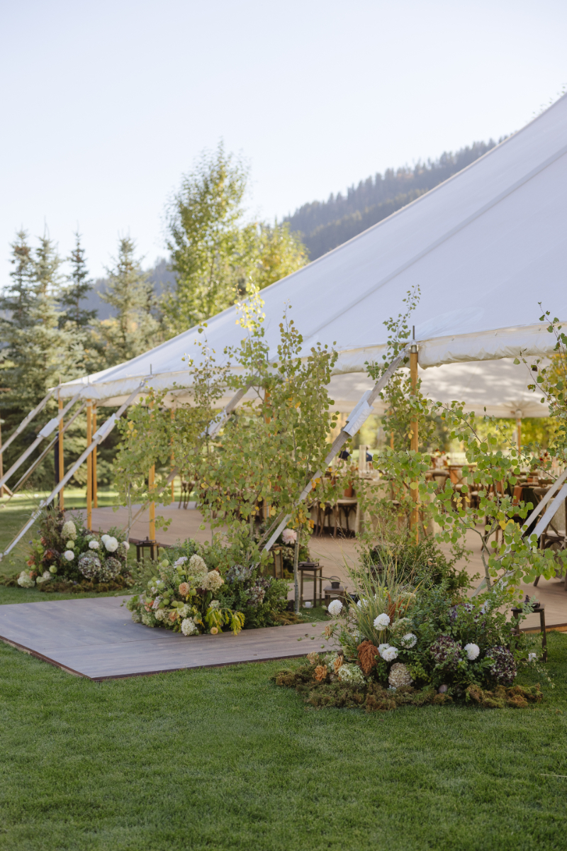 Exterior view of the elegant sailcloth reception tent at Snake River Sporting Club in autumn