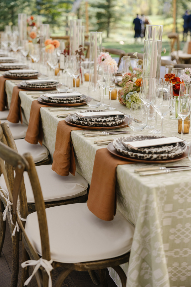 Beautifully styled reception tablescape with floral centerpieces at Snake River Sporting Club wedding