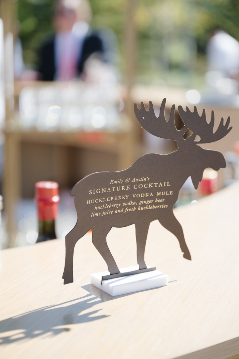 Custom moose-shaped signature cocktail sign at a Snake River Sporting Club wedding bar