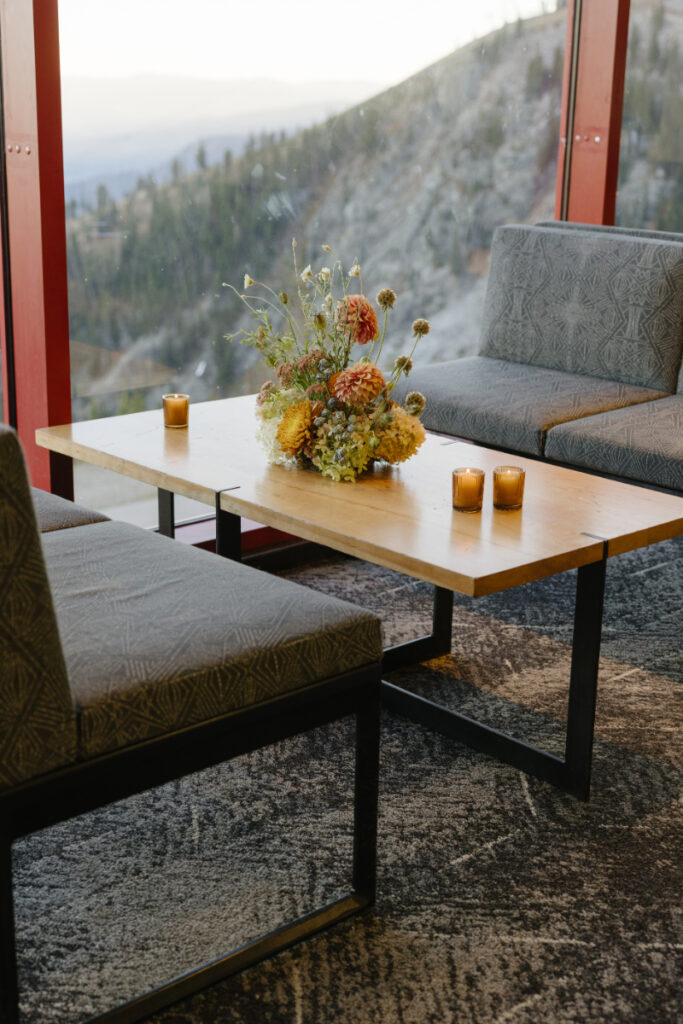 Lounge seating with floral arrangements overlooking mountain views at Jackson Hole Mountain Resort's Rendezvous Lodg