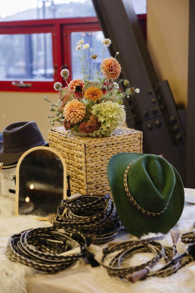 Western-themed welcome party accessories with cowboy hats and bandanas at Rendezvous Lodge