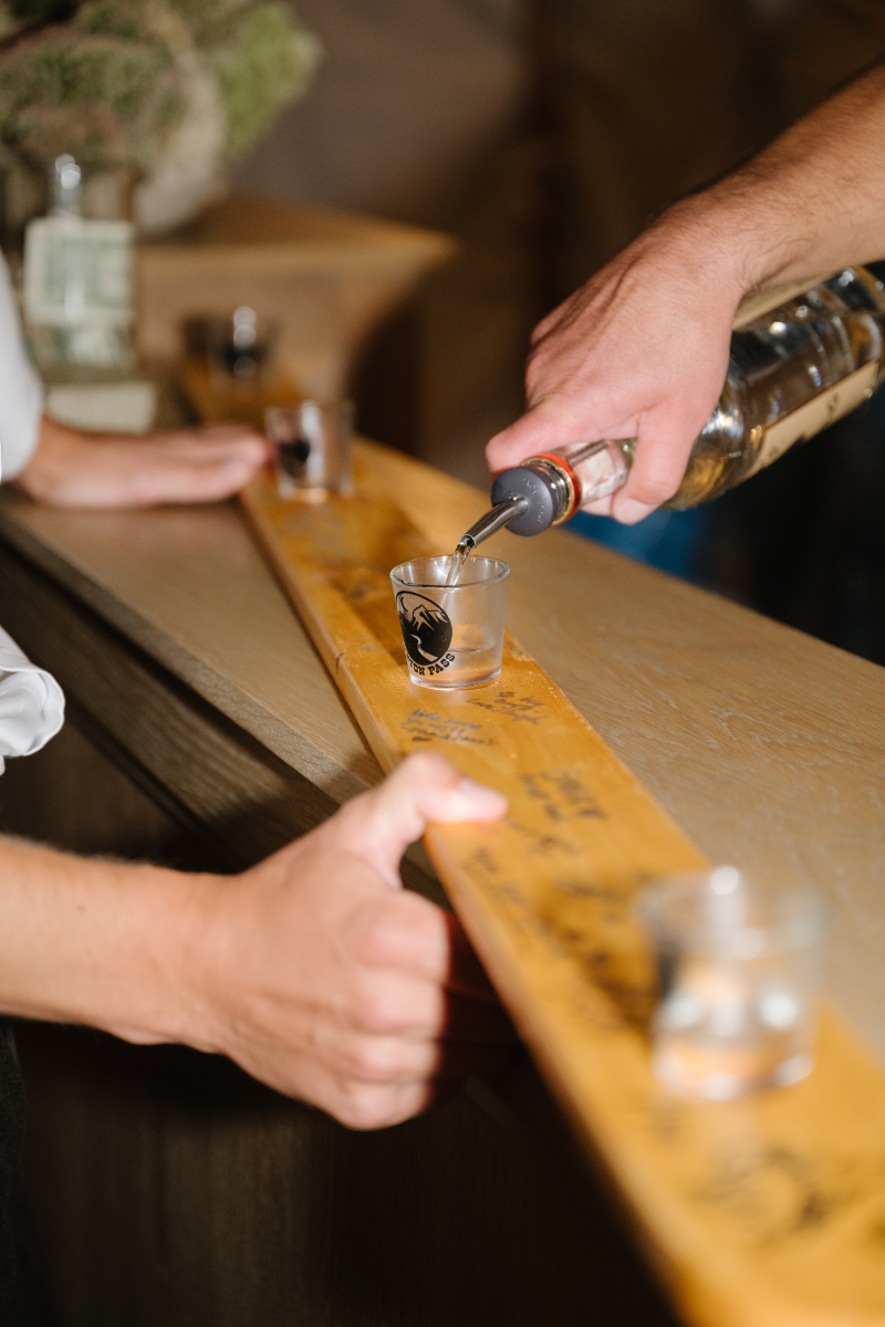 Guests enjoying a ski shot tradition during the Snake River Sporting Club wedding reception