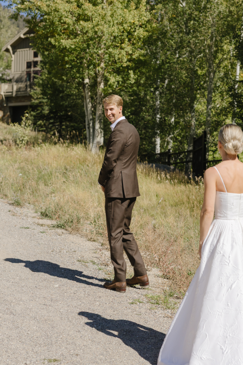 Groom turning around to face bride during their first look.