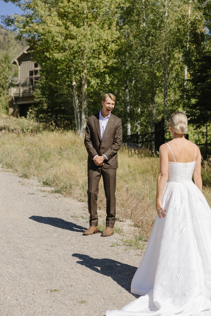 Groom turning around to face bride during their first look.
