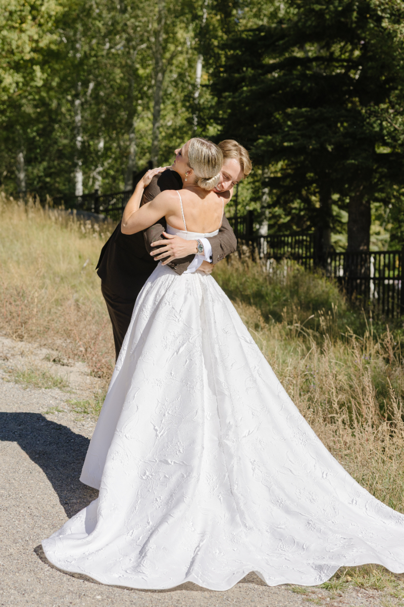 Bride and groom hug during emotional moment of their first look at Snake River Sporting Club.