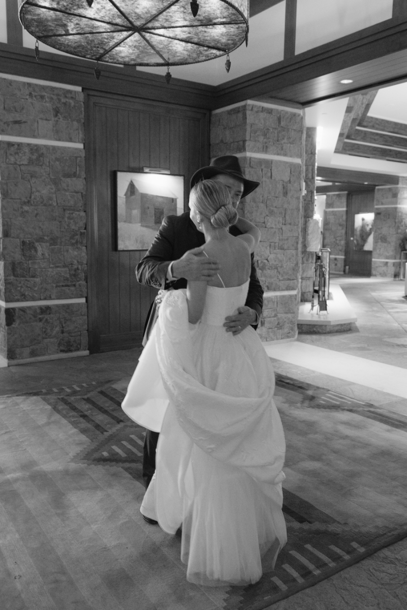 Black and white photo of bride and father's first look on the wedding day.
