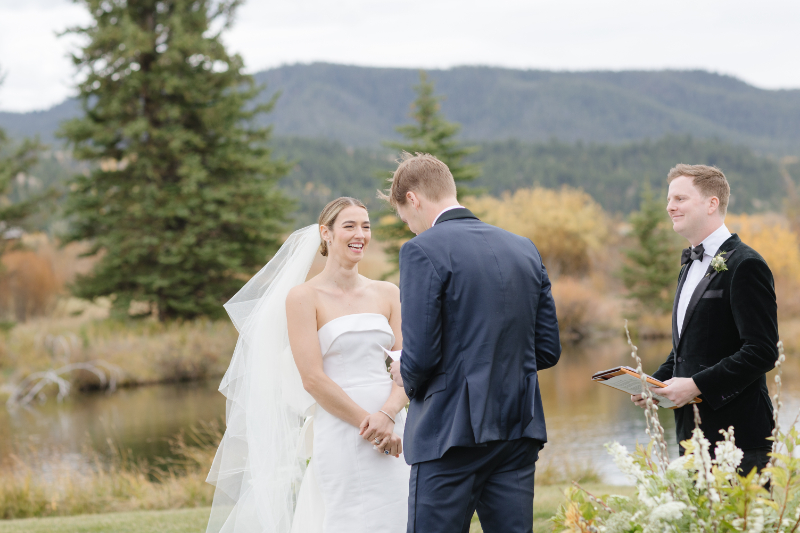 Jackson Hole Wyoming wedding ceremony beside a pond surrounded by fall scenery