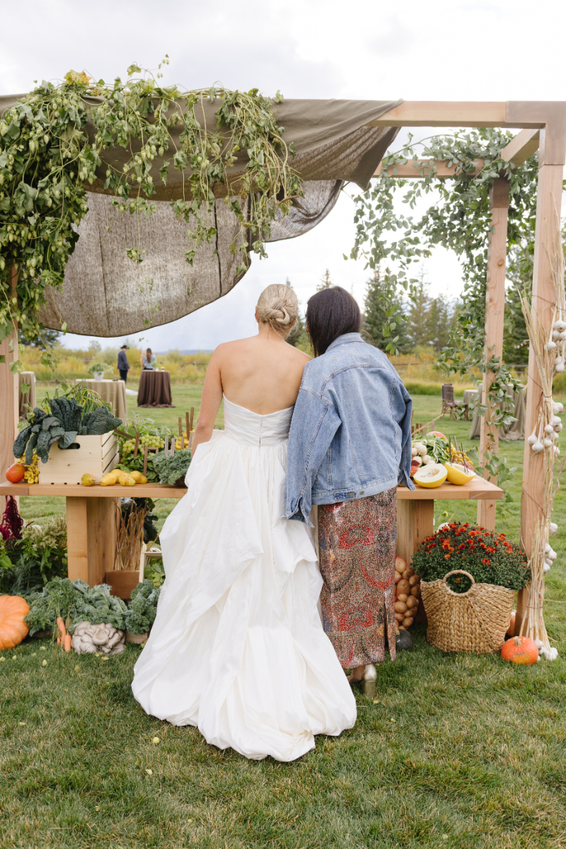Bride admiring a garden-inspired wedding display during an outdoor Jackson Hole celebration