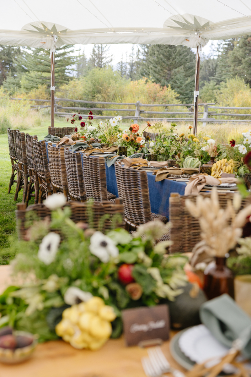 Outdoor cocktail hour with Teton mountain views and seasonal wedding decor