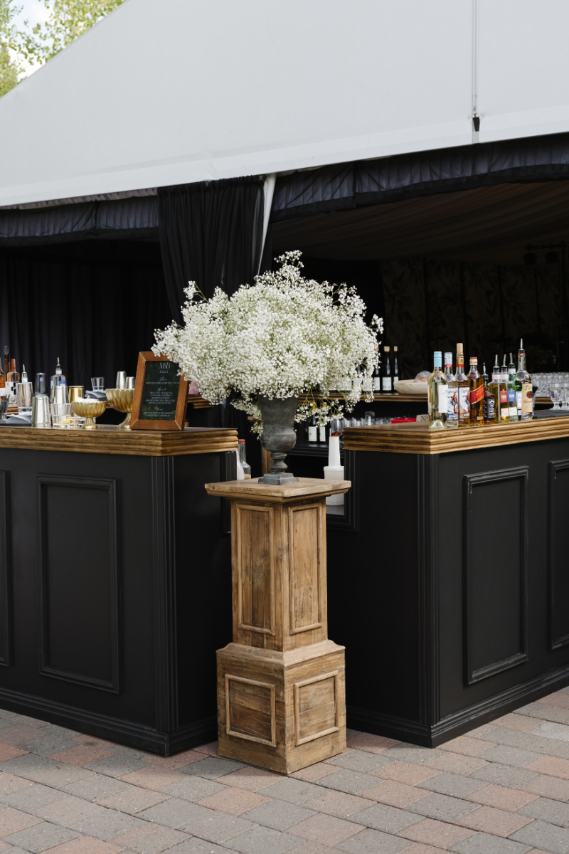 Elegant outdoor bar with white florals for a Jackson Hole wedding welcome party near the best restaurants in Jackson Hole