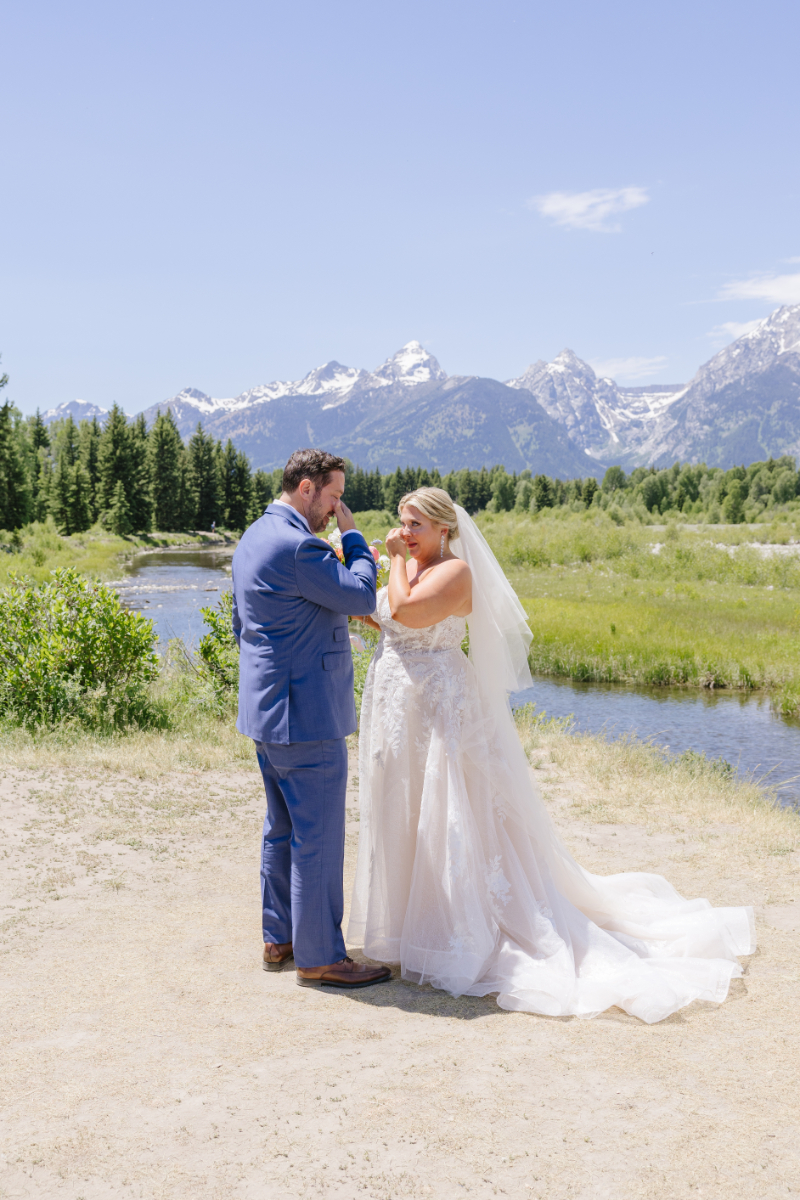 Wedding photography ideas for an emotional first look with the bride and groom beneath the Tetons