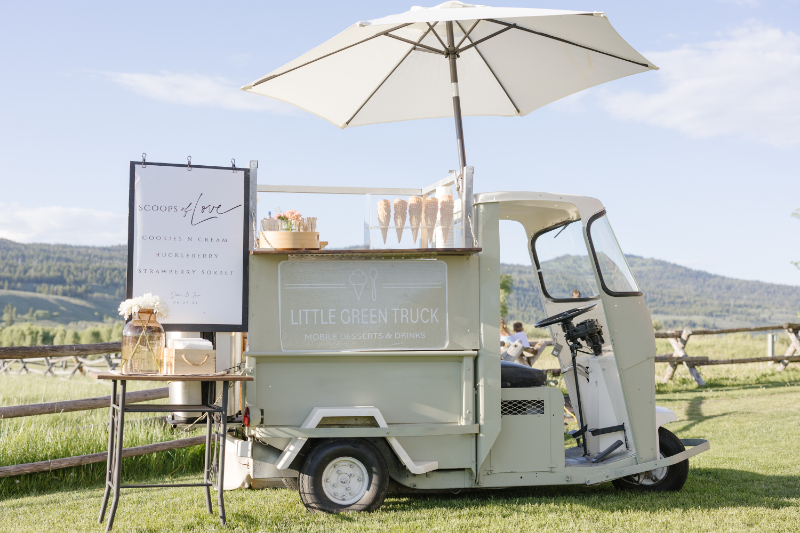 Little Green Truck ice cream cart set up for a wedding, with the Teton mountains framing the background.