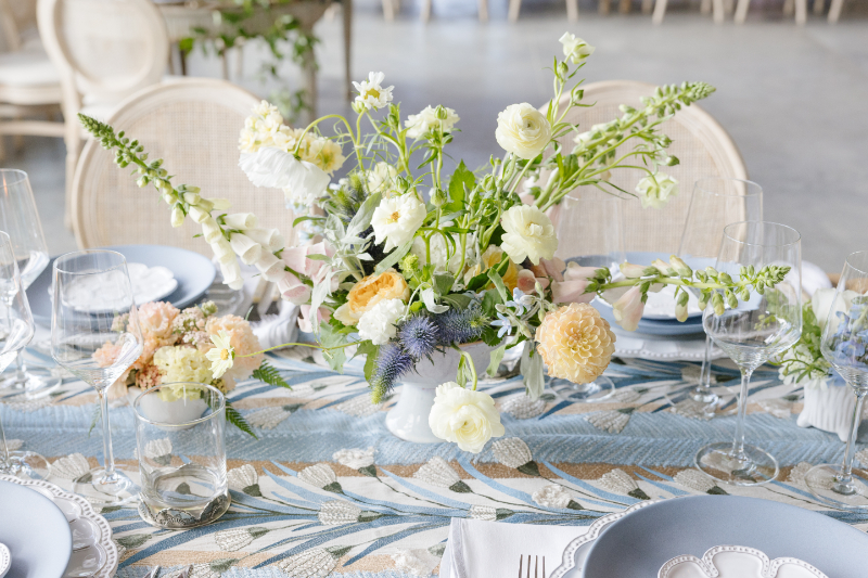 Wedding photography ideas featuring a colorful floral tablescape with blue linens and elegant place settings